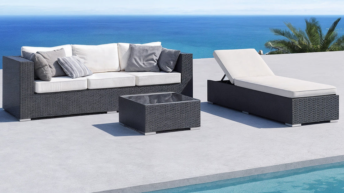 Stylish outdoor daybed and wicker sofa set on a poolside patio overlooking the ocean, showcasing a perfect blend of comfort and modern outdoor style.