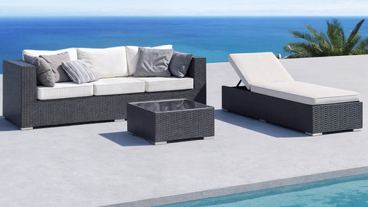 Stylish outdoor daybed and wicker sofa set on a poolside patio overlooking the ocean, showcasing a perfect blend of comfort and modern outdoor style.