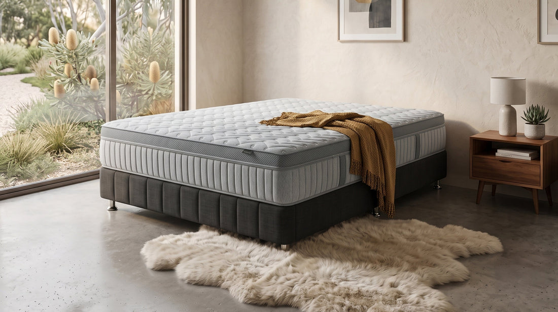 Grey mattress on black bed base with timber bedside table