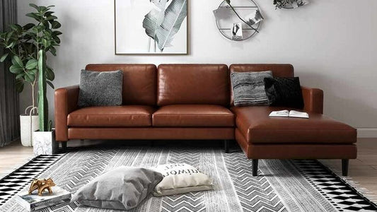 Cozy living room decorating ideas for autumn featuring a brown leather chaise sofa, plush cushions, and a patterned rug for a warm, inviting space.