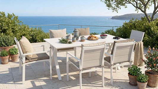 White outdoor dining set with panel chairs and ocean view