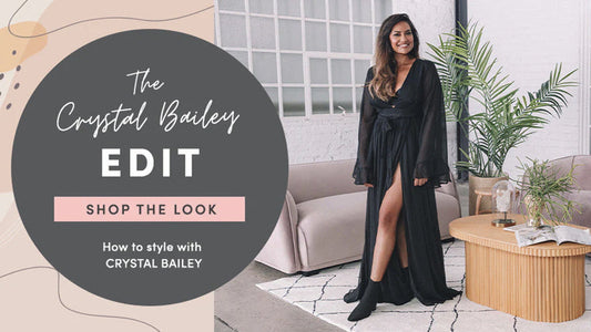 Crystal Bailey in a stylish, pink-toned Palm Springs living room with mid-century modern furniture, demonstrating how to style the space for a chic, desert-inspired look.