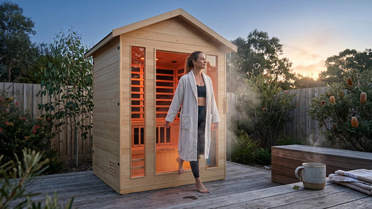 Woman leaving outdoor timber sauna with steam on backyard deck