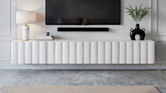 White fluted floating TV entertainment unit with wall-mounted television.
