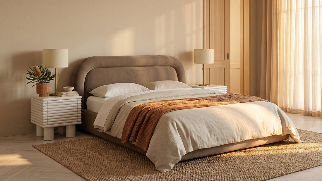 Beige upholstered bed with matching bedside tables in warm bedroom