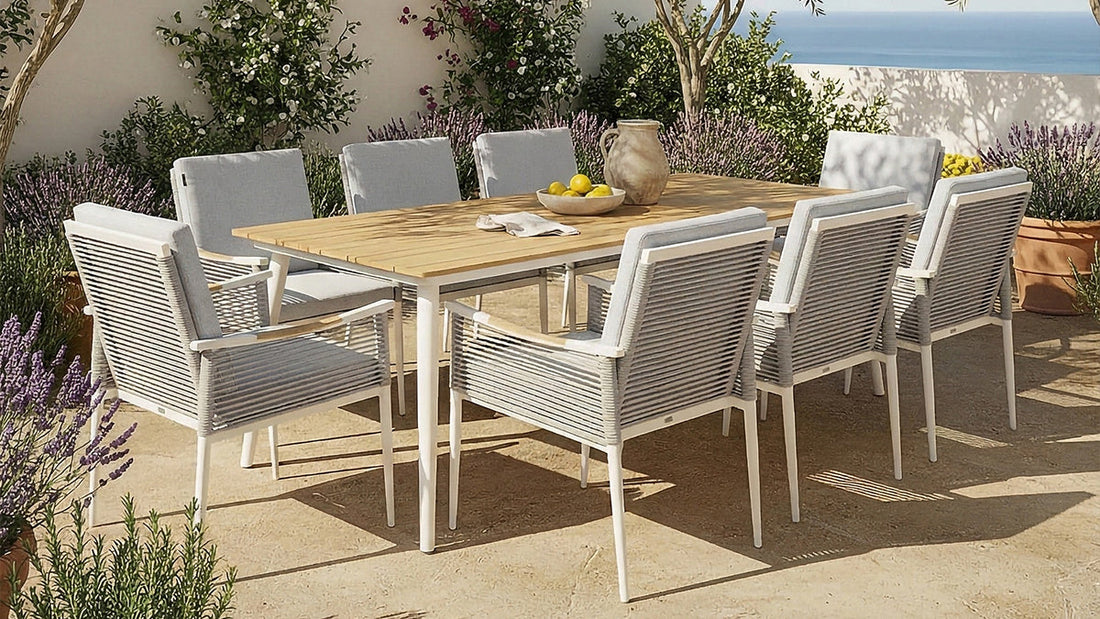 White outdoor dining set with timber table and cushioned chairs on patio