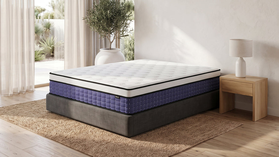 Purple hybrid mattress on grey bed base in bright neutral bedroom
