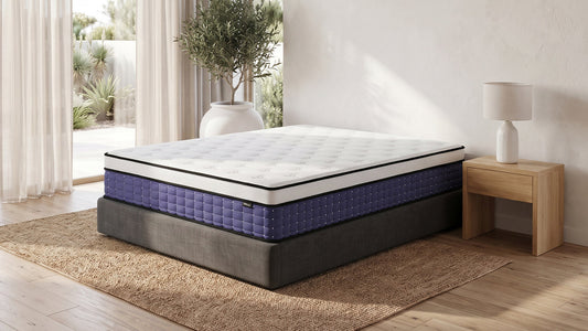 Purple hybrid mattress on grey bed base in bright neutral bedroom
