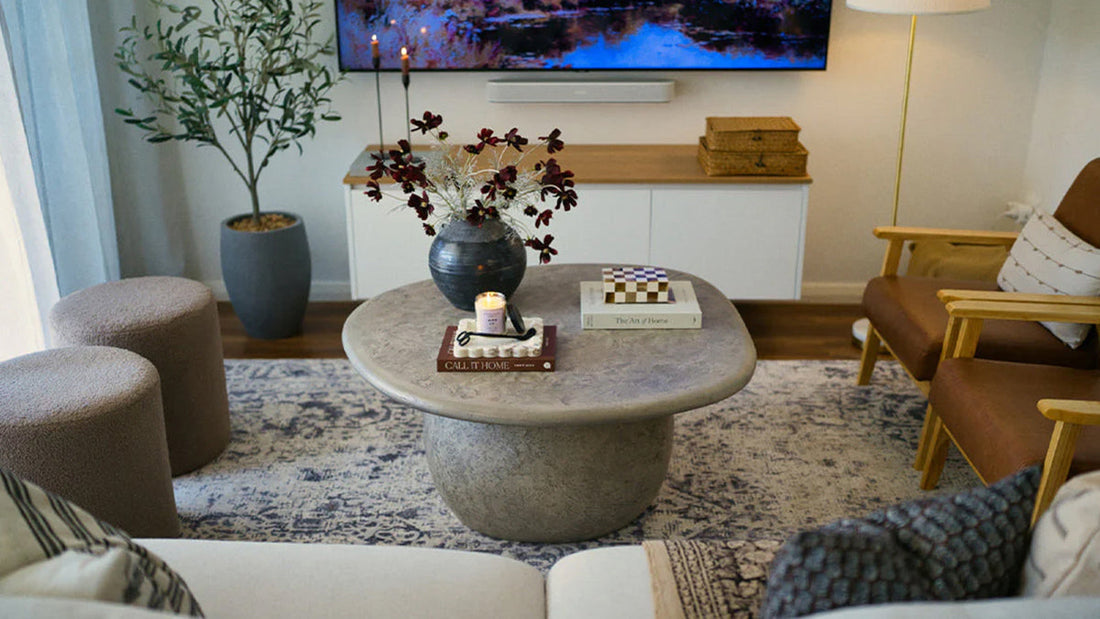 Luxo Living sculptural curved concrete coffee table in living room setting