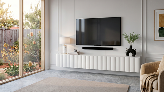 Minimalist wall-mounted entertainment console under a large television overlooking a bright backyard view.