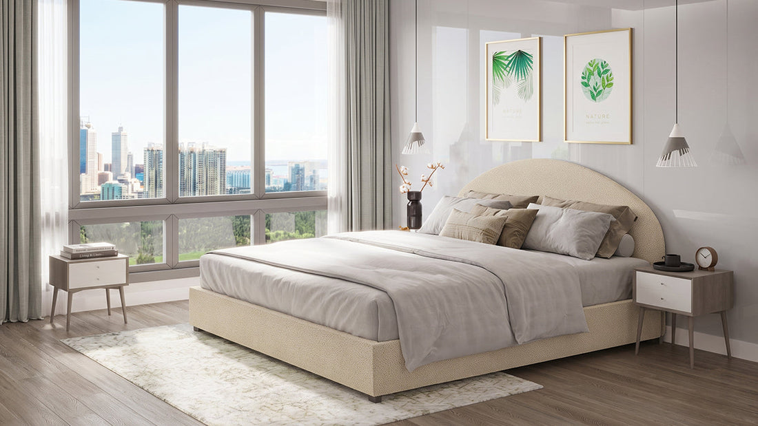 Cream upholstered bed with curved headboard in modern city bedroom