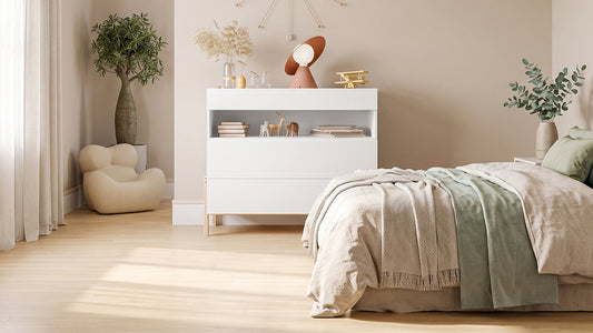 White storage cabinet beside neutral bed in bright bedroom