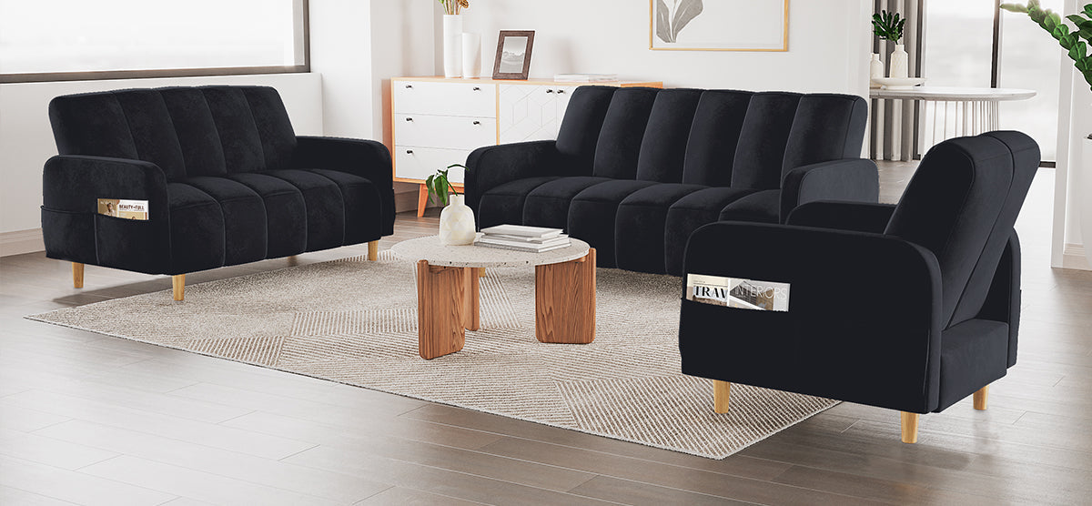A modern living room with a black channel-tucked sofa, loveseat, and armchair around a round coffee table. Light geometric rug, white sideboard, and abstract art in background.