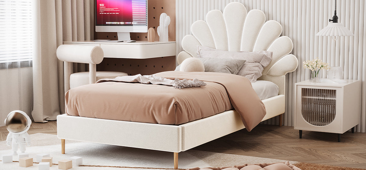 A modern bedroom with a scalloped headboard bed, terracotta bedding, cream nightstand, floating desk, astronaut figurine on floor, and linen drapes filtering soft light.