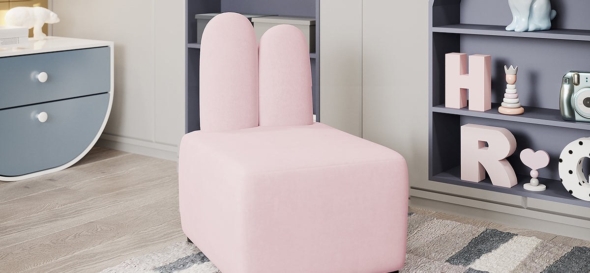 A pastel-themed child's nook with a pink ear chair, slate blue shelving with pink blocks and toys, and a pale blue cabinet with a polar-bear figurine.