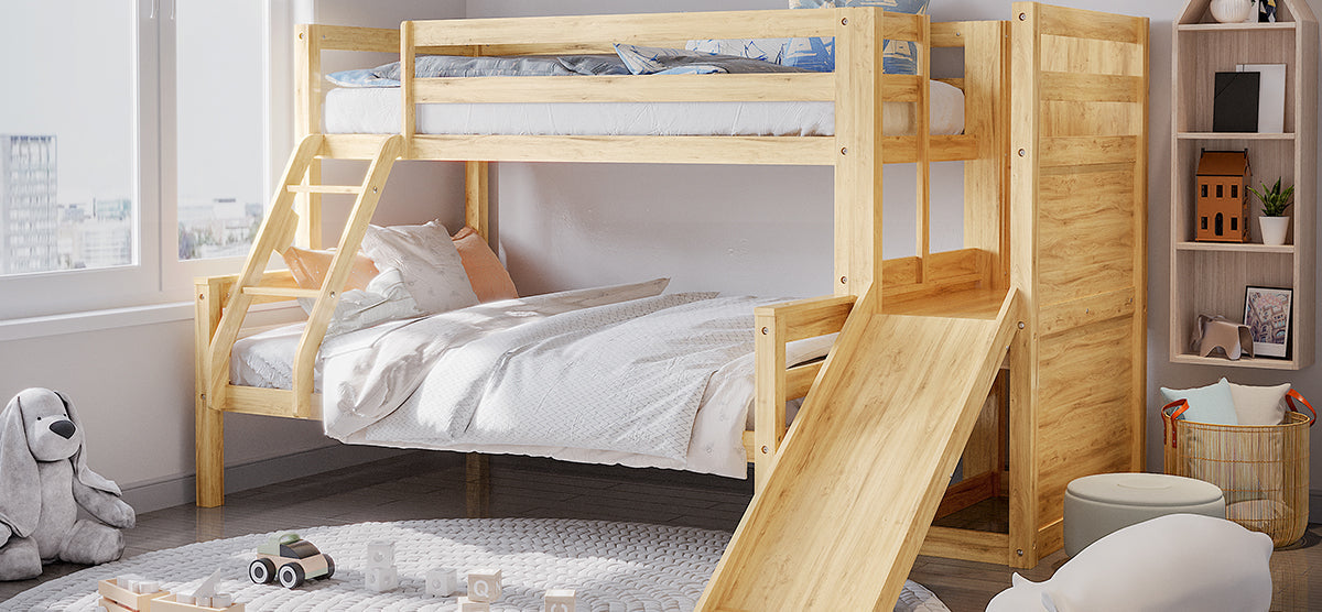 Children's room with a light-wood bunk bed featuring a slide, pastel bedding, a braided rug with toys, plush dog, poufs, and a basket with pillows.