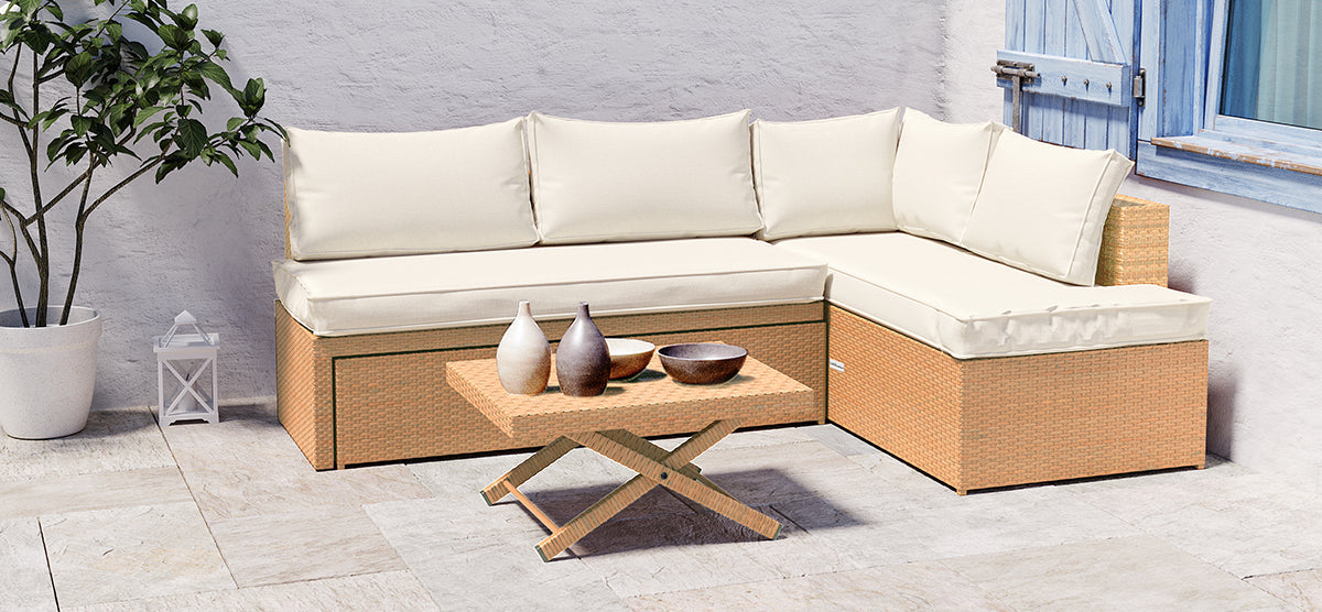 L-shaped wicker sofa with cream cushions, low coffee table with decorative vessels, white potted plant, small lantern, on stone-tile patio with blue-shuttered window.