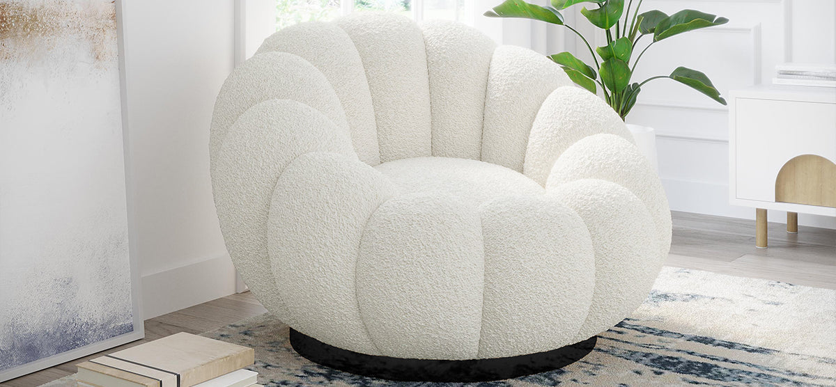 Modern shell-shaped lounge chair in textured off-white boucle fabric with a dark swivel base, set on a patterned rug, beside a white media console and abstract artwork.
