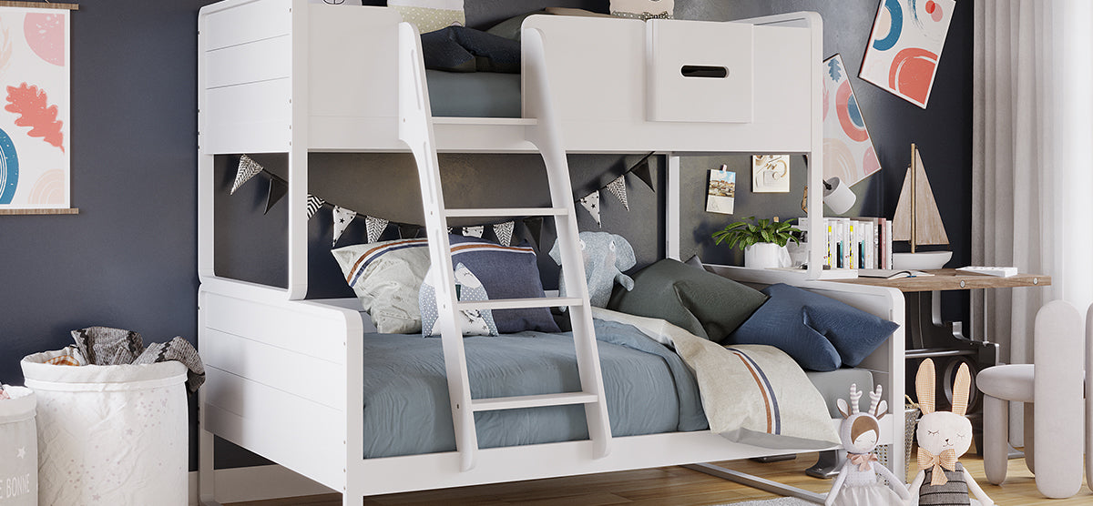 Children’s bedroom corner with a white wooden bunk bed, plush elephant, abstract art, small desk with books and model sailboat, and fabric rabbit dolls on wood flooring.