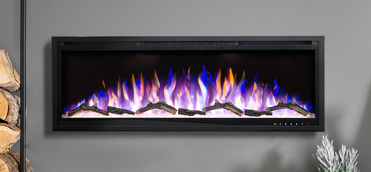 Modern wall-mounted electric fireplace with simulated logs and multicolored flames. Nearby, a small stack of real firewood and decorative foliage enhance the cozy ambiance.