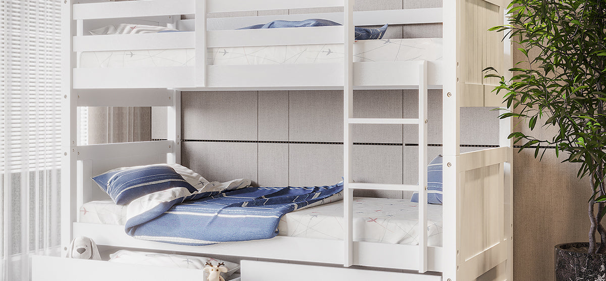 A bright, modern bedroom corner with a white wooden bunk bed, featuring striped bedding, a plush toy, a climbing ladder, and a tall potted plant by a sunlit window.