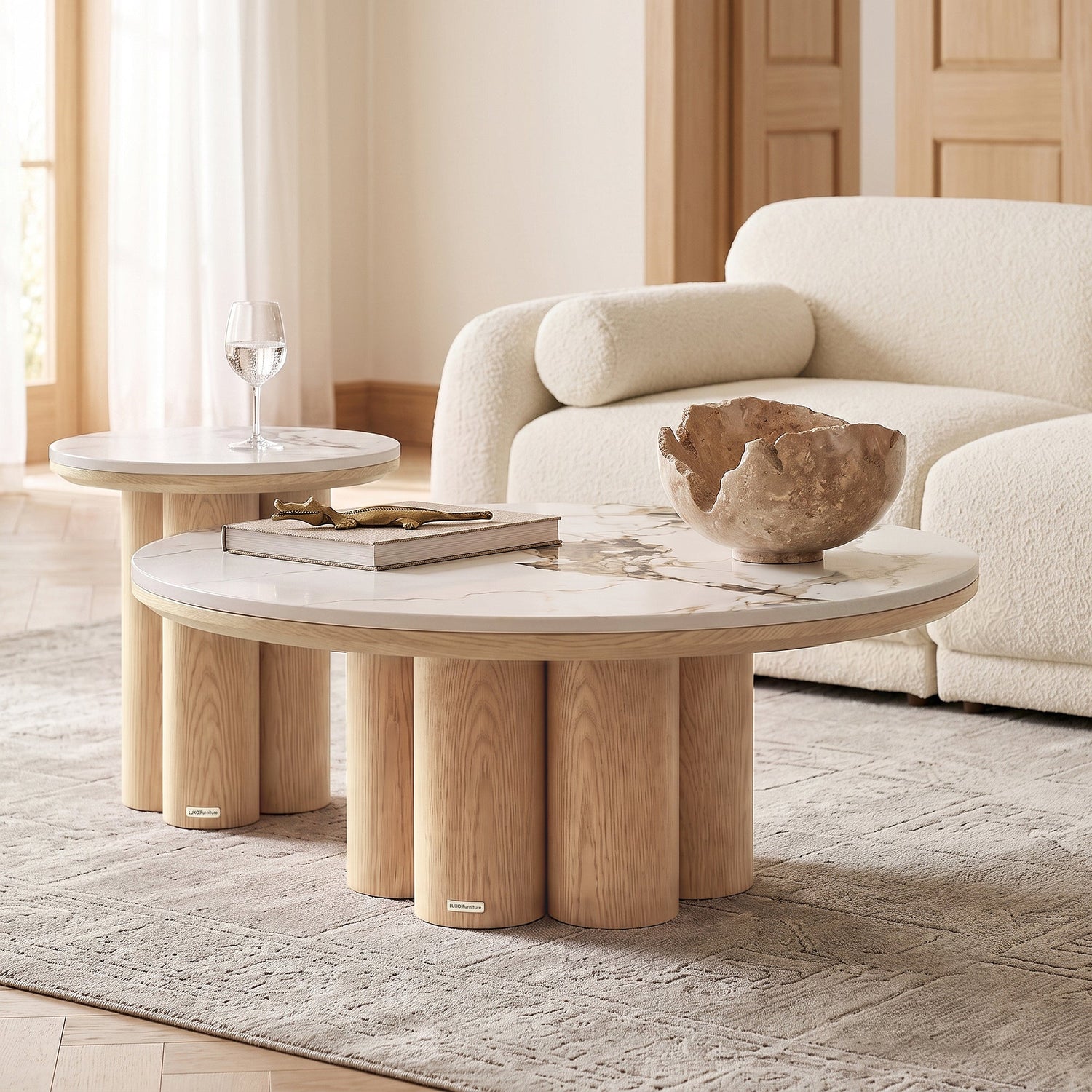 Two round coffee tables styled in a modern living room with a sofa and decor