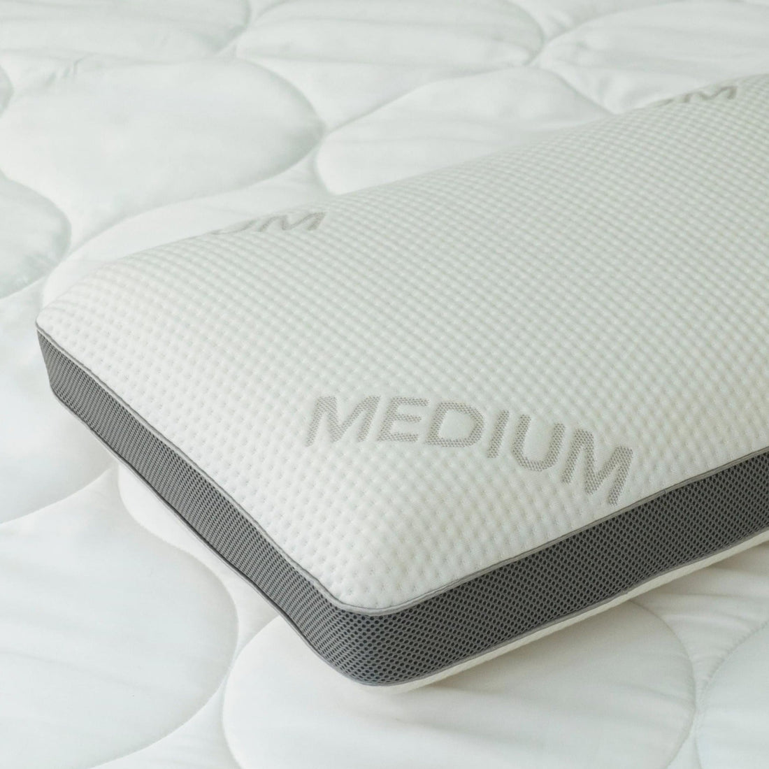 Close-up of the Medium variant's corner, showing the grey mesh gusset panel and "Medium" label
