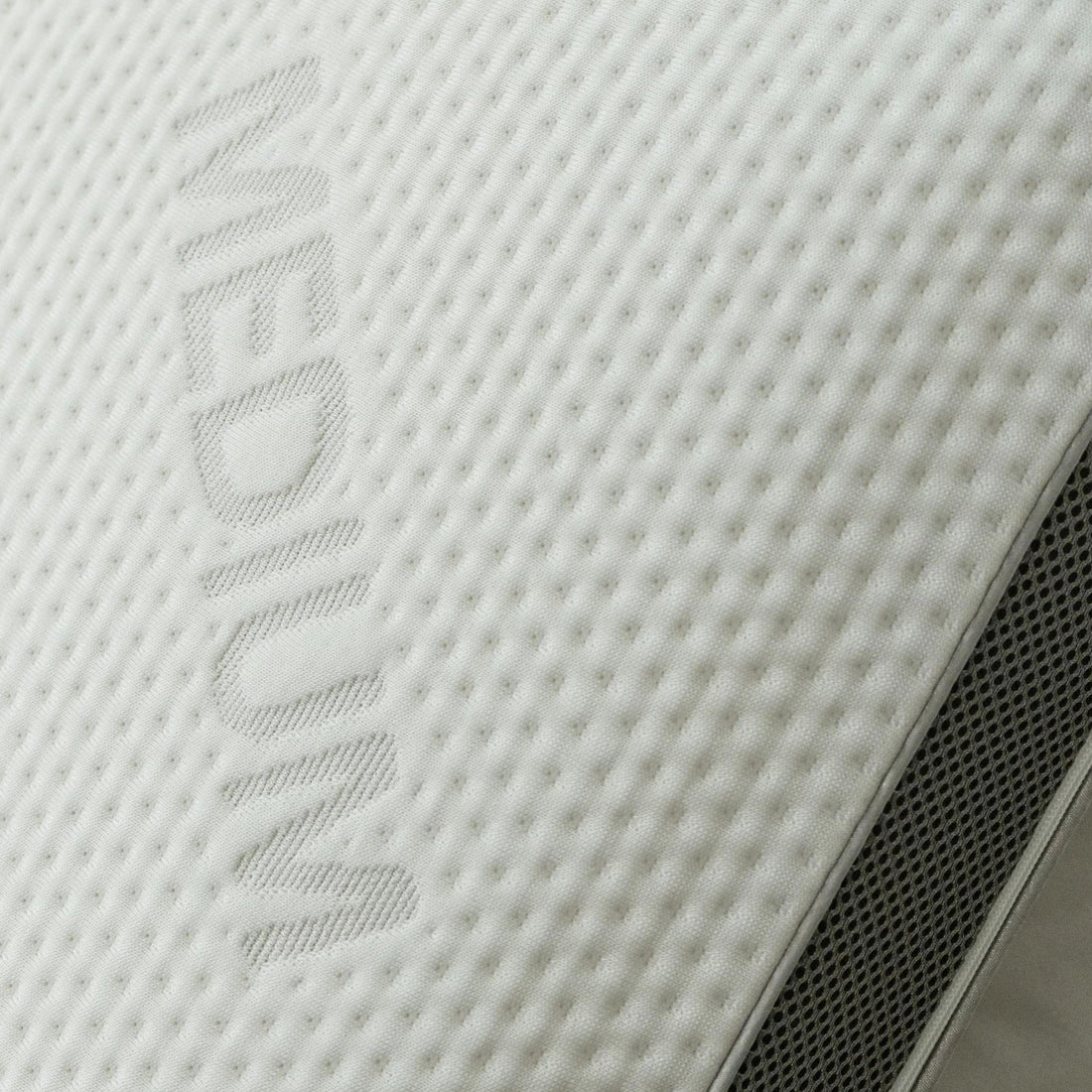 Close-up of the Tencel jacquard fabric weave with the grey gusset edge visible