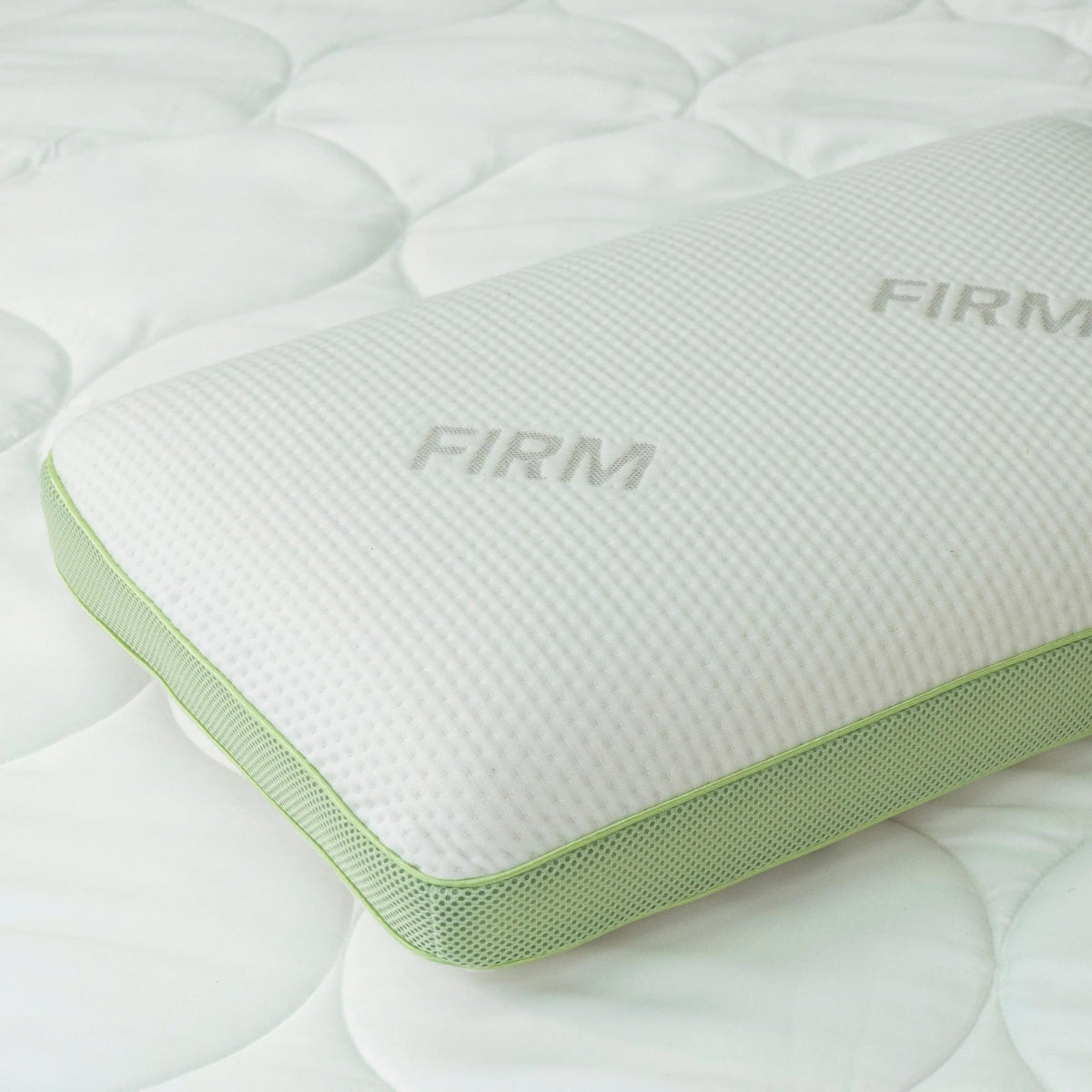 Close-up of the Firm variant's corner, showing the green mesh gusset panel and "Firm" label