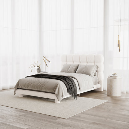 Aina Double Boucle Bed Frame in Cream White features a tufted headboard in soft bouclé fabric, set in a light-filled bedroom with elegant decor, including brass accents and neutral-toned furnishings.