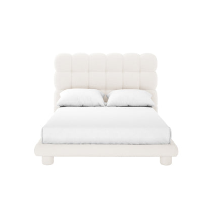 Aina Double Boucle Bed Frame in Cream White features a modern, upholstered design with a low-profile frame, rounded feet, and a tall, grid-style tufted headboard, complemented by white bedding and pillows.