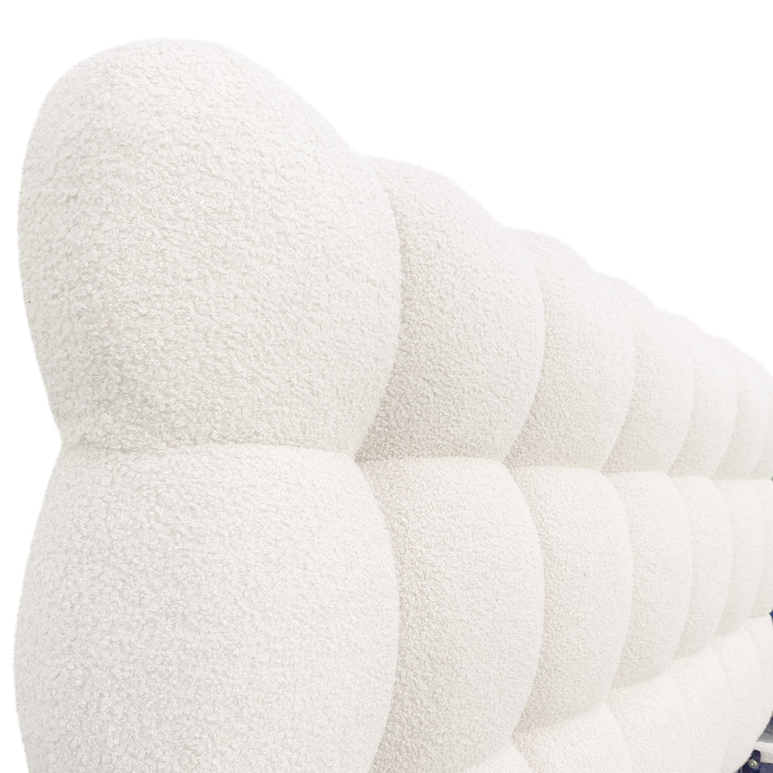 Aina Double Boucle Bed Frame in Cream White features a close-up of its tufted, pillowy headboard with a nubby bouclé texture, showcasing luxurious and elegant craftsmanship.