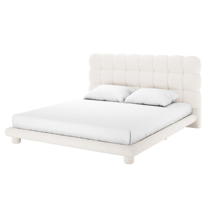 Aina King Boucle Bed Frame in Cream White featuring a wide, padded, grid-tufted headboard in creamy boucle fabric, resting on short cylindrical legs, paired with a simple white mattress and pillows.