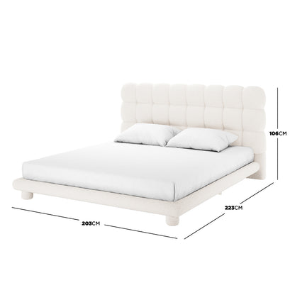 Aina King Boucle Bed Frame in Cream White, featuring a tall tufted headboard, off-white bouclé fabric, chunky cylindrical legs, and an expansive platform design, offering elegance and comfort.