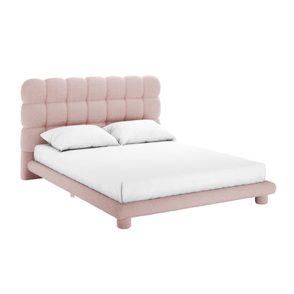Aina Queen Boucle Bed Frame in Pink features a modern, low-profile design with a grid-quilted, tufted headboard upholstered in soft pink boucle fabric, complemented by a white sheet and pillows.