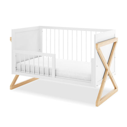 Aldwin & Melai Solid Pine Baby Cot with Convertible Rail Set White features a white-painted rectangular wooden frame with vertical slats and natural-wood “X”-style legs, holding a plain white mattress.