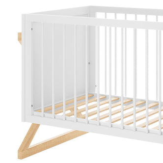 Aldwin & Melai Solid Pine Baby Cot with Convertible Rail Set White features a white-painted wooden frame with vertical slats, angled natural-wood legs, and wood slats for mattress support in a mid-century style.