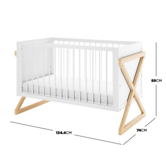 Aldwin & Melai Solid Pine Baby Cot with Convertible Rail Set White, featuring a modern design with natural-wood X-shaped legs, white finish, and dimensions marked on the side.