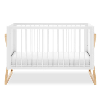 Aldwin Pine Adjustable Baby Cot - White/Natural, featuring white slatted side panels and a simple white mattress, supported by light-wood X-leg base, showcasing a modern and functional design.