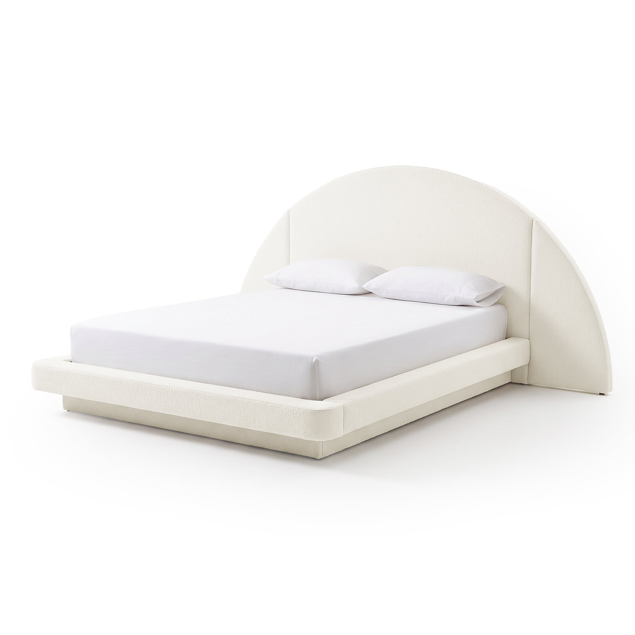 Modern upholstered bed with curved headboard, mattress, and pillows on a white background