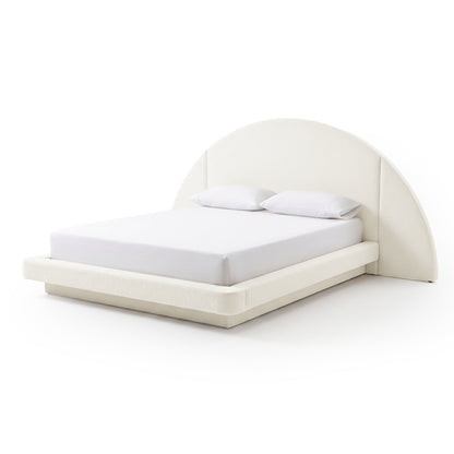 Modern upholstered bed with curved headboard, mattress, and pillows on a white background