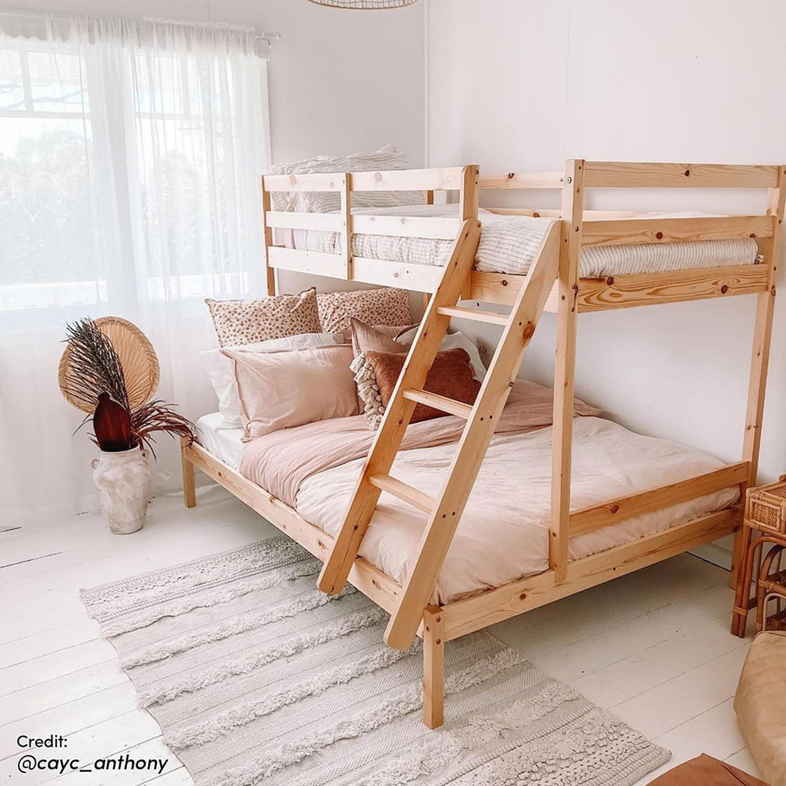 Antonia Solid Pine Wood Triple Bunk Bed - Natural features a sturdy pine frame with a double bottom and single top bunk, complete with guard rails and a reversible ladder for safety and convenience.