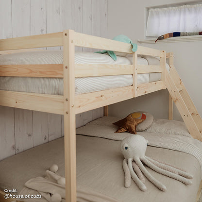 Antonia Wooden Triple Bunk Bed - Natural displayed in a cozy room setting, highlighting its solid pine frame and triple bunk configuration with a double bottom and single top bunk.