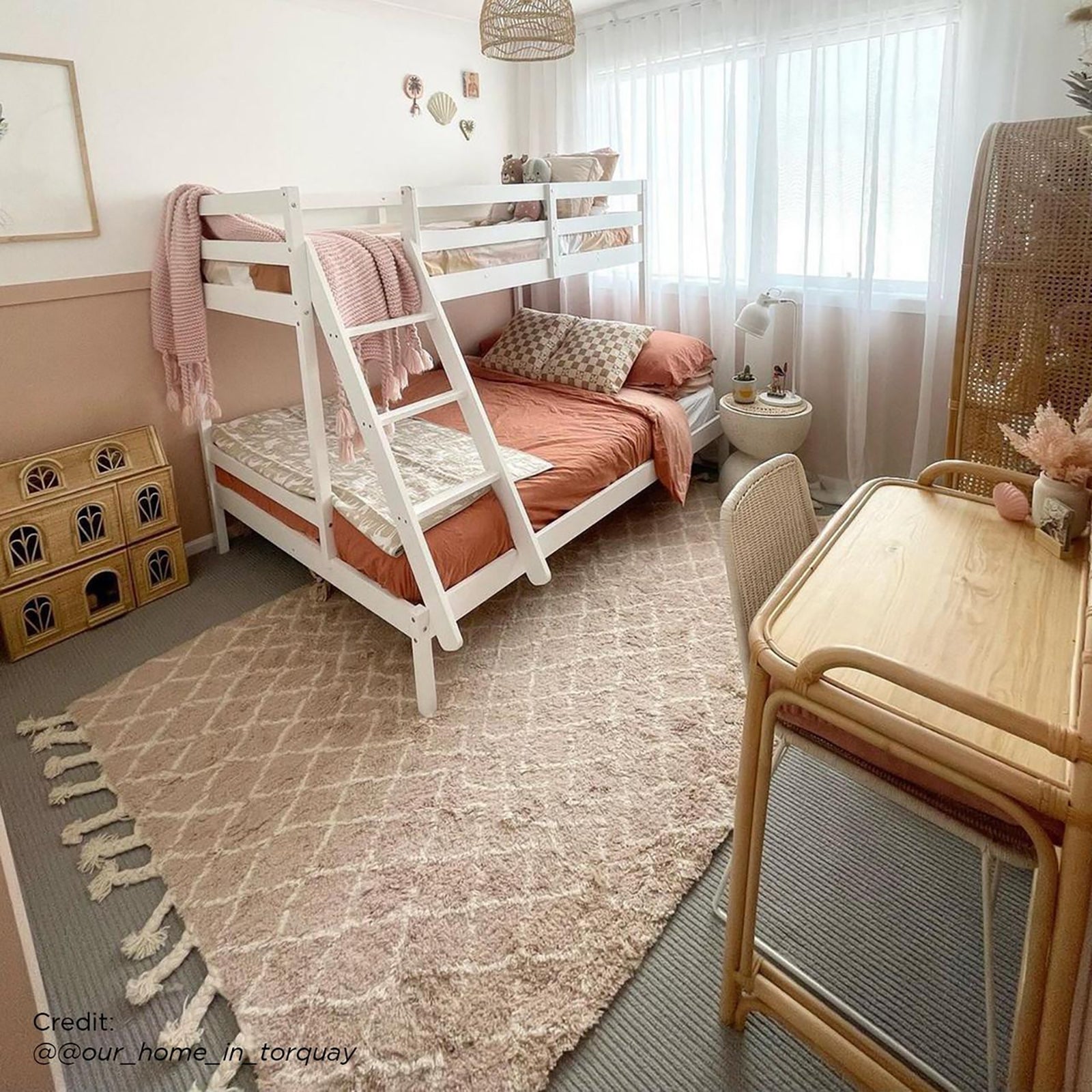 Antonia Solid Wood Triple Bunk Bed - White in a room, showcasing a double-size bottom bunk, single-size top bunk, and secure guard rails, with a reversible ladder for flexible layouts.