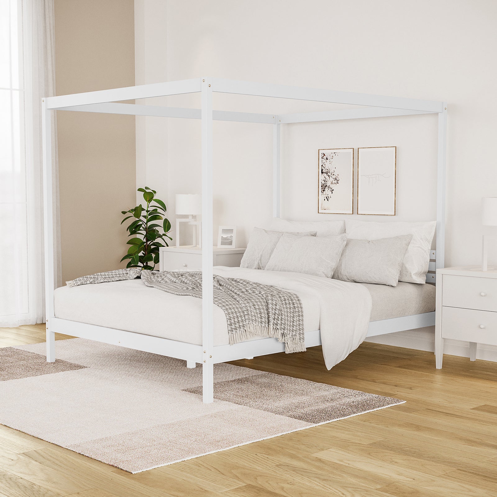 Aurelius Queen Solid Pine 4-Post Canopy Bed Frame in White, featuring elegant posts, light-neutral bedding, and abstract wall art, complemented by white nightstands and a cozy area rug in a serene bedroom corner.