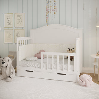 Azeem & Giro Baby Cot with Gydas 10cm Nursery Mattress, featuring a padded bumper, heart-shaped cushion, plush deer toy, and a pastel mobile above, creating a serene sleep environment.