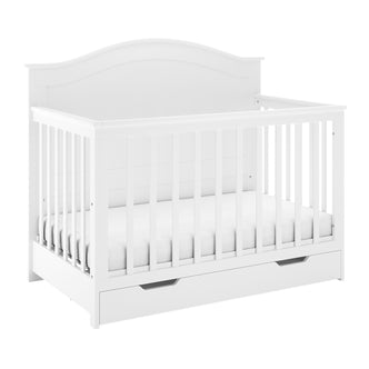 Azeem 3-in-1 Adjustable Solid Pine Baby Cot – White features vertical slats, a curved headboard, a fitted mattress, and an under-cot storage drawer, showcasing a versatile and safe nursery solution.