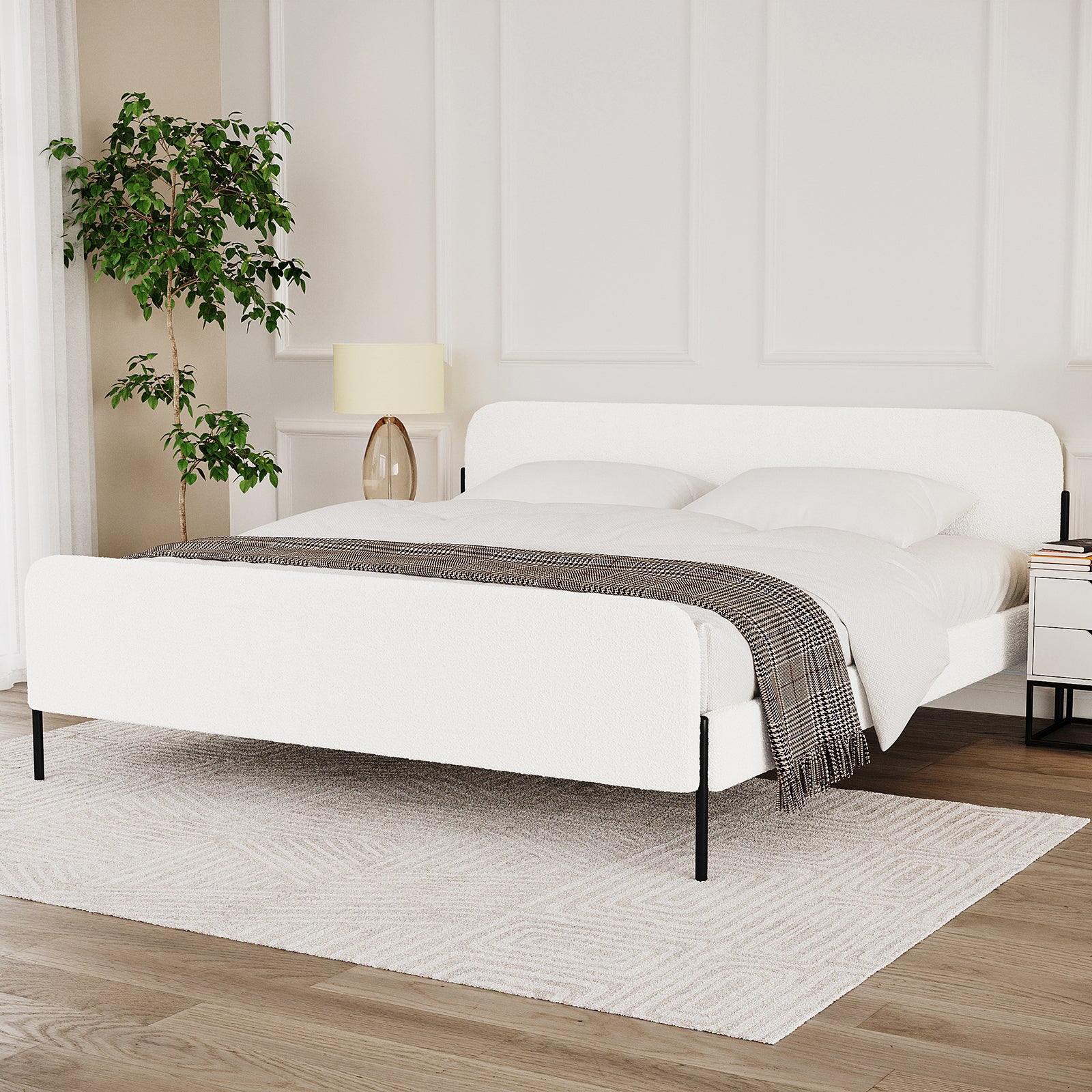 Bonny King Boucle Bed Fabric Frame in Cream White, featuring boucle upholstery, low-profile design, and sleek metal legs, set in a minimalist bedroom with a check-patterned throw and modern bedside table.