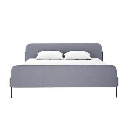 Bonny King Boucle Bed Frame in Grey featuring a light grey upholstered headboard and footboard, sleek black metal legs, white mattress, and pillows, showcasing modern elegance and luxurious design.