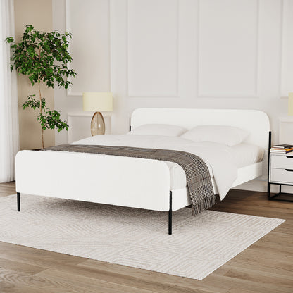 Bonny Queen Boucle Fabric Bed Frame in Cream White with upholstered headboard and footboard, slim black metal legs, and white bedding against a paneled wall, flanked by nightstands and a potted plant.